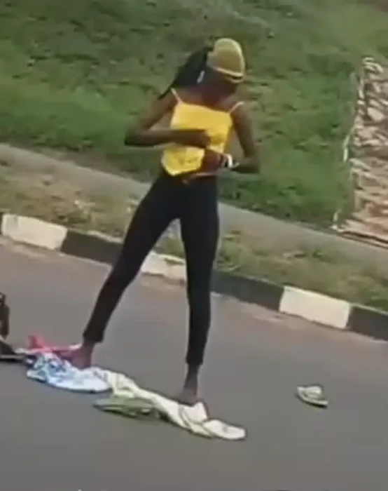 Lady runs mad after being dropped by an alleged yahoo boy in middle of a road